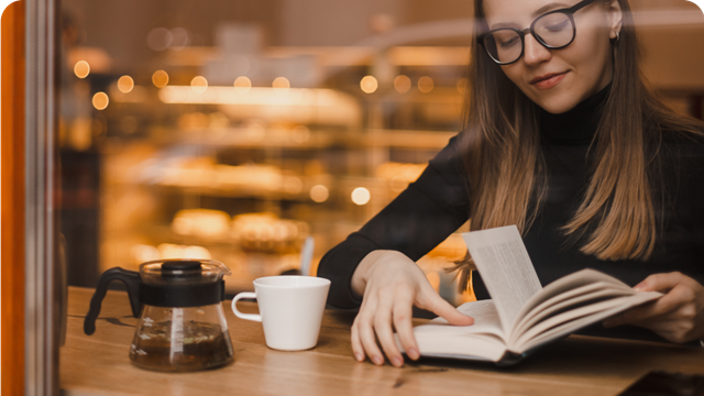 a woman reading in a cafe