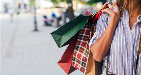 A woman holding many shopping bags