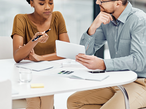 A man in discussion with a woman in an office