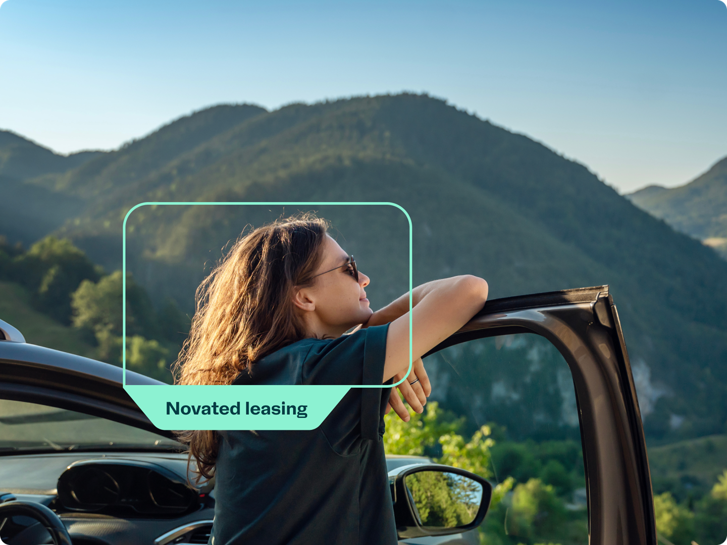 A woman enjoying the view from her car