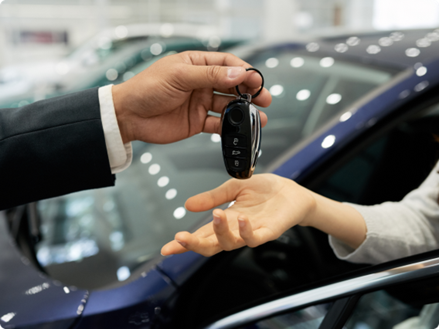 hand over car key to another hand