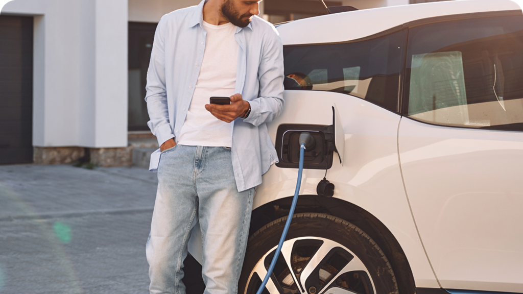 man stand next to an EV being charged