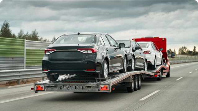 Cars being transported on a trailer  